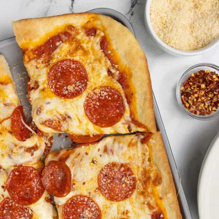 sheet pan pizza plus cheese and peppers