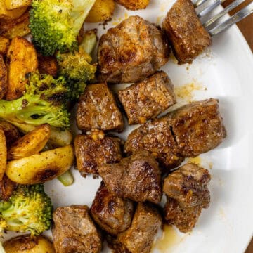 Garlic Butter Steak Bite on a plate with Potatoes and Broccoli